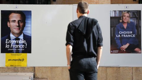 A man looks at election posters of the French presidential candidates, Emmanuel Macron and Marine Le Pen, at the French consulate in Jerusalem, on May 7. French citizens worldwide are casting their votes during the second round of the country's presidential vote.  