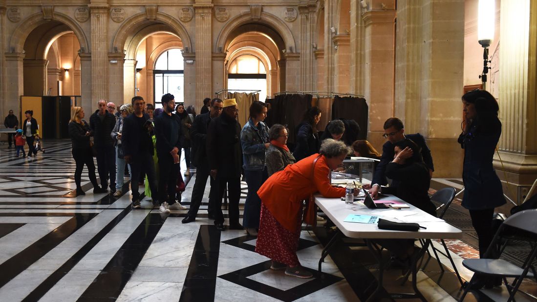 People queue at a polling station in Marseille, France.