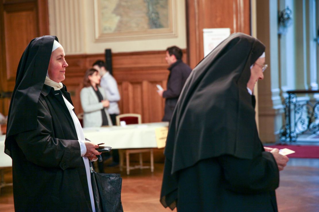 Nuns from the Benedictine Sisters of the Sacred Heart in Montmartre cast their votes at a polling station in the 18th district of Paris. 