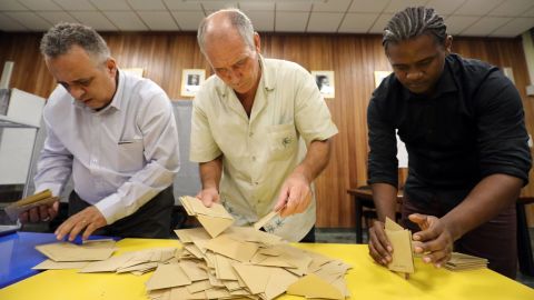 Polling officials count the ballots on May 7, in Saint-Denis de la Reunion, on the French Indian Ocean island of La Reunion. French citizens worldwide are casting their votes during the second round of the country's presidential vote. 
