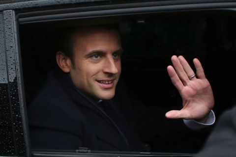 Macron waves as he leaves a polling station after casting his ballot in Le Touquet, France, on May 7.