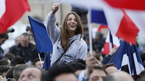 A supporter of Emmanuel Macron celebrates in front of the Louvre Museum in Paris on Sunday.