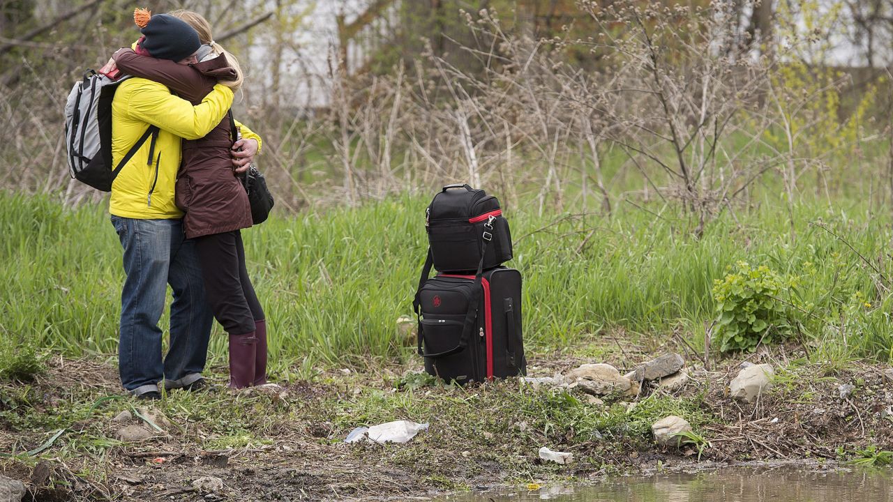 A woman and a man embrace after she evacuated her home in Montreal on May 7.