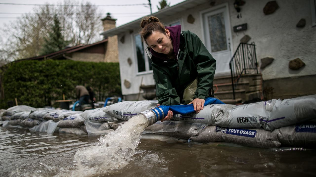 A resident of Mercier Island drains her house of floodwaters.