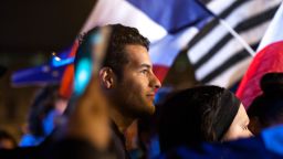 Young Parisians celebrate Emmanuel Macron's victory at a rally at the Louvre Sunday night.