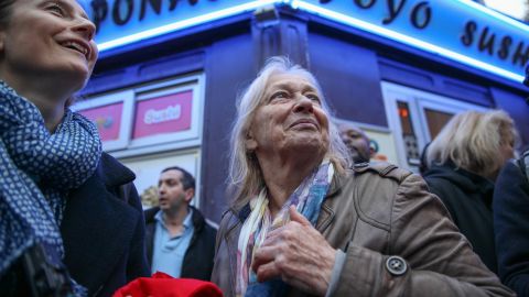 Sabine Gruhier (L), of Paris' 15th district, gathers with her neighbors on the street outside Macron's headquarters moments before the polls close on election day.