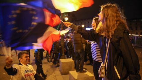 Parisians dance and cheer at the Macron victory rally on Sunday night.