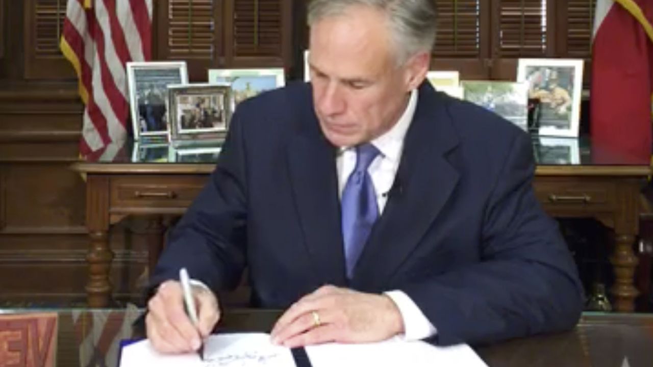 In this Sunday, May 7, 2017 frame from video posted by the Office of the Governor, Republican Gov. Greg Abbott signs a so-called "sanctuary cities" ban in Austin Texas. The ban lets police ask during routine stops whether someone is in the U.S. legally and threatens sheriffs with jail if they don't cooperate with federal immigration agents.