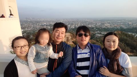 Kim's wife, left, and Kim, center, in a photograph with other family members.
