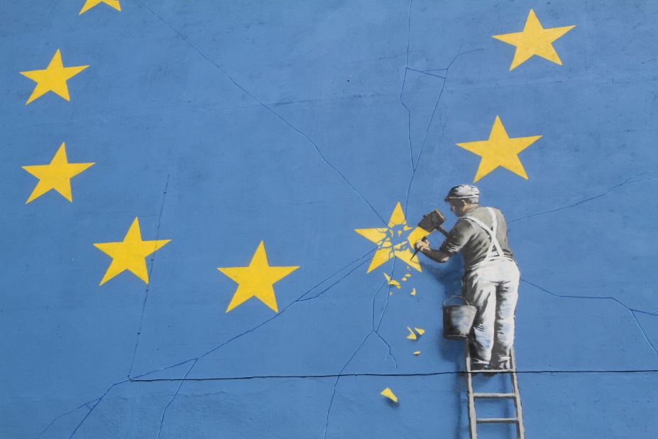 Elusive street artist Banksy has revealed a new mural. The large-scale painting depicts a worker chipping away at one of the twelve stars on the European Union flag. 