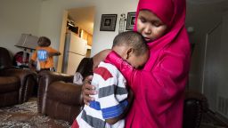 Suaado Salah comforts her son Luqman, 3, at their apartment in Hopkins, Minnesota on April 27. Luqman and his 18-month-old sister got the measles during the current outbreak in Minneapolis and are now fully healing at home. Brother Abdullahi, 5, left, did not get sick and has now been vaccinated. Salah had previously refused the MMR shot for them because of rumors that it caused autism. She has since changed her mind and is upset that the connection is still being touted by anti-vaxxers. 