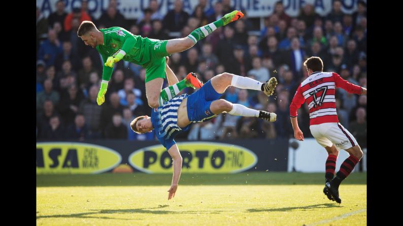 Ian Lawlor, a goalkeeper for Doncaster Rovers, collides with Hartlepool's Rhys Oates during a League Two match in Hartlepool, England, on Saturday, May 6.