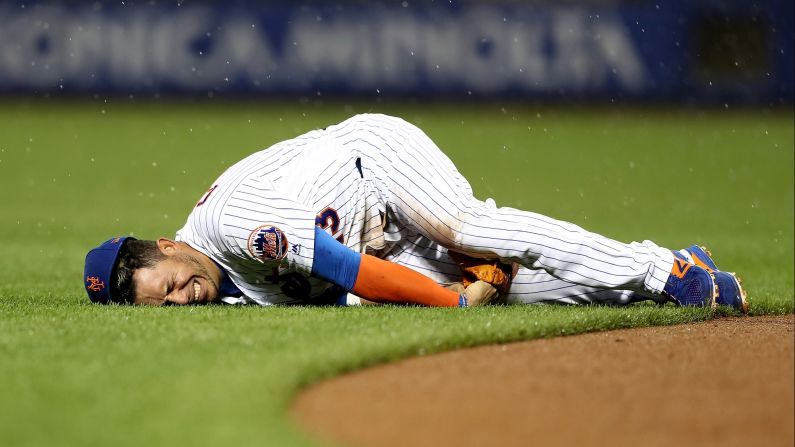 Asdrubal Cabrera grimaces after injuring his thumb during a Major League Baseball game in New York on Saturday, May 6. Cabrera, a shortstop for the New York Mets, hurt himself while diving for a ground ball. 