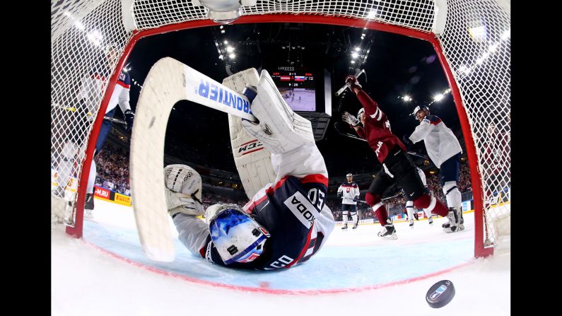 Latvia's Miks Indrasis, right, celebrates a goal against Slovakia during the World Championships on Sunday, May 7. Latvia won the preliminary-round game 3-1.