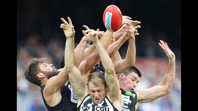 Players compete for the ball during an Australian Football League match in Melbourne on Saturday, May 6. Facing the camera, from left, are Ben Reid, Matthew Kreuzer and Levi Casboult.