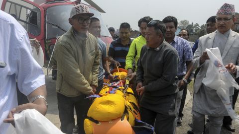 Officials carry Min Bahadur Sherchan's body to a hospital in Kathmandu on May 7.