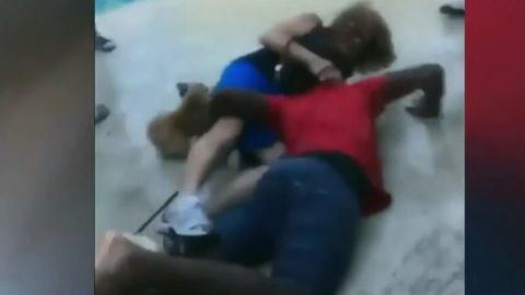 The video shows a teenager and a woman falling in a pool area in North Lauderdale, Florida.
