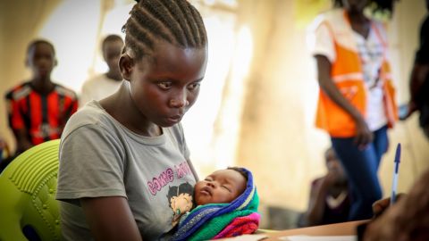 Blessing sits in a processing center, cradling her days-old infant hoping that one day she will be reunited with her parents. As a young mother with a baby daughter Blessing will receive special protection and services.