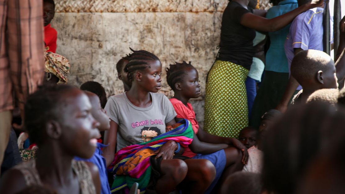 Blessing Akujo sits with her newborn daughter after fleeing her homeland of South Sudan, leaving her parents behind.