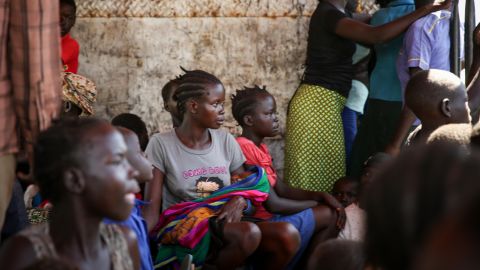 Blessing Akujo sits with her newborn daughter after fleeing her homeland of South Sudan, leaving her parents behind.