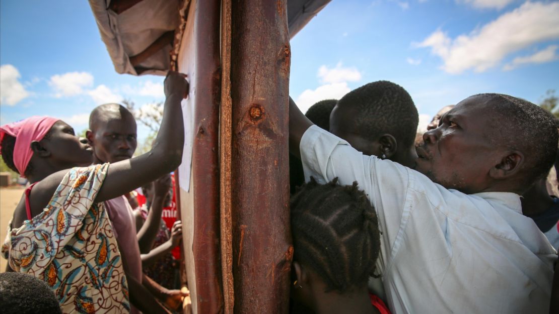 New arrivals search for their registration number at Uganda's Imvepi Refugee Camp. Once on the list, they can begin the process of settling on a plot of land and within five years, the hope is that they become self-sustainable.