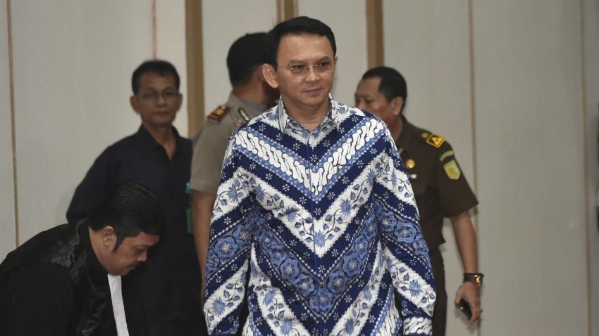 Jakarta Governor Basuki "Ahok" Tjahaja Purnama, center, enters the court room as he attends his sentencing hearing in Jakarta, Indonesia, Tuesday, May 9, 2017. The minority Christian governor is currently on trial on accusation of blasphemy following his remark about a passage in the Quran that could be interpreted as prohibiting Muslims from accepting non-Muslims as leaders. (Bay Ismoyo/Pool Photo via AP)