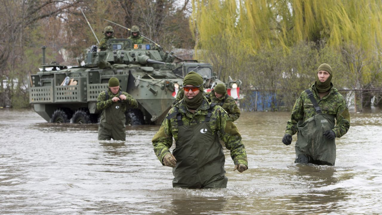 Canadian armed forces wade through flooded streets as they provide assistance in Deux-Montagnes, Quebec, on May 8.