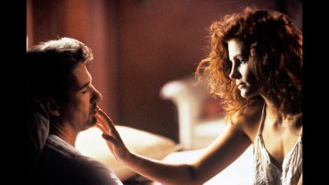 In "Pretty Woman," Julia Roberts' character, Vivian, is about to break her self-imposed rule as a lady of the night: never kiss a "trick." To the vast delight of Edward (Richard Gere), she follows though on this tender touch with a passionate kiss, and he falls hard for her in this 1990 release.