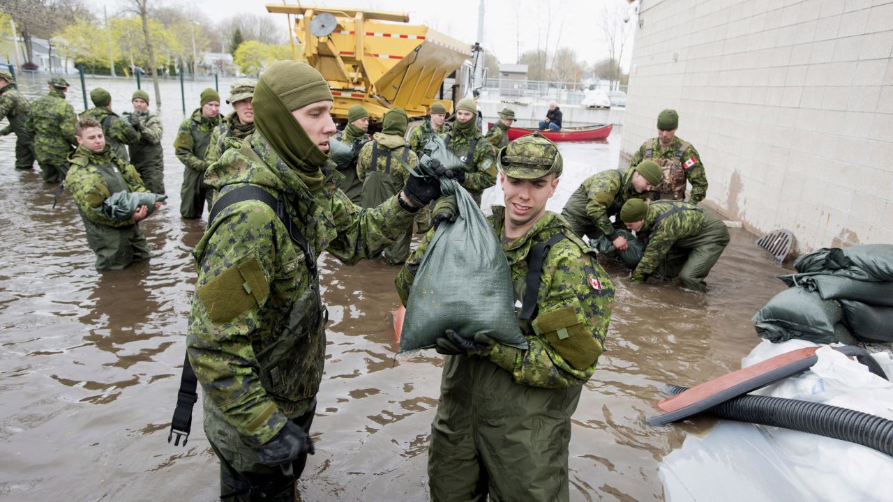 Canadian Forces personnel unload sandbags in Deux-Montagnes, Quebec.