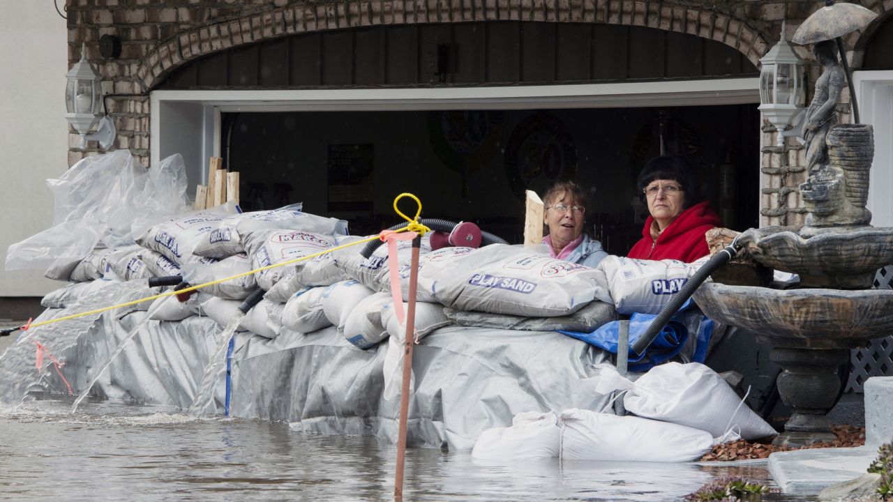 Residents look out from their garage over sandbags in Ile Bizard, Quebec.