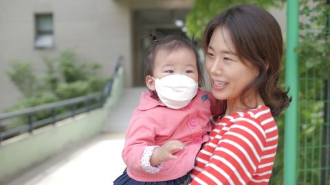 Yoon Ji-na with her 18-month-old daughter says she wants her country to return to normal.
