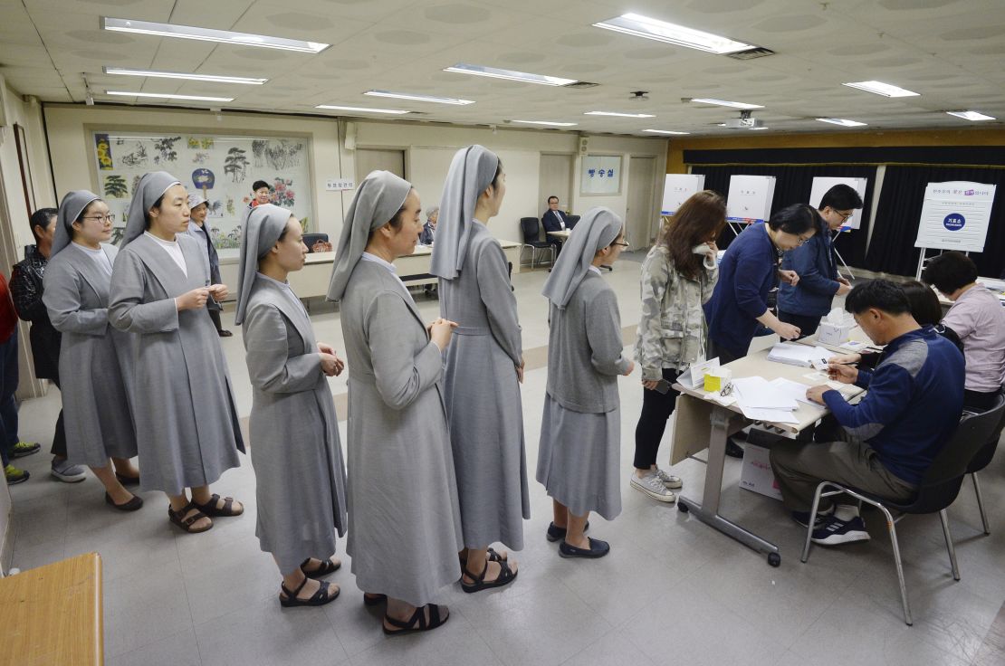 South Korean Catholic nuns line up to cast their ballots Tuesday in Seoul.