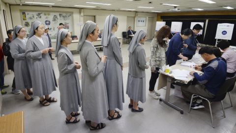 South Korean Catholic nuns line up to cast their ballots Tuesday in Seoul.