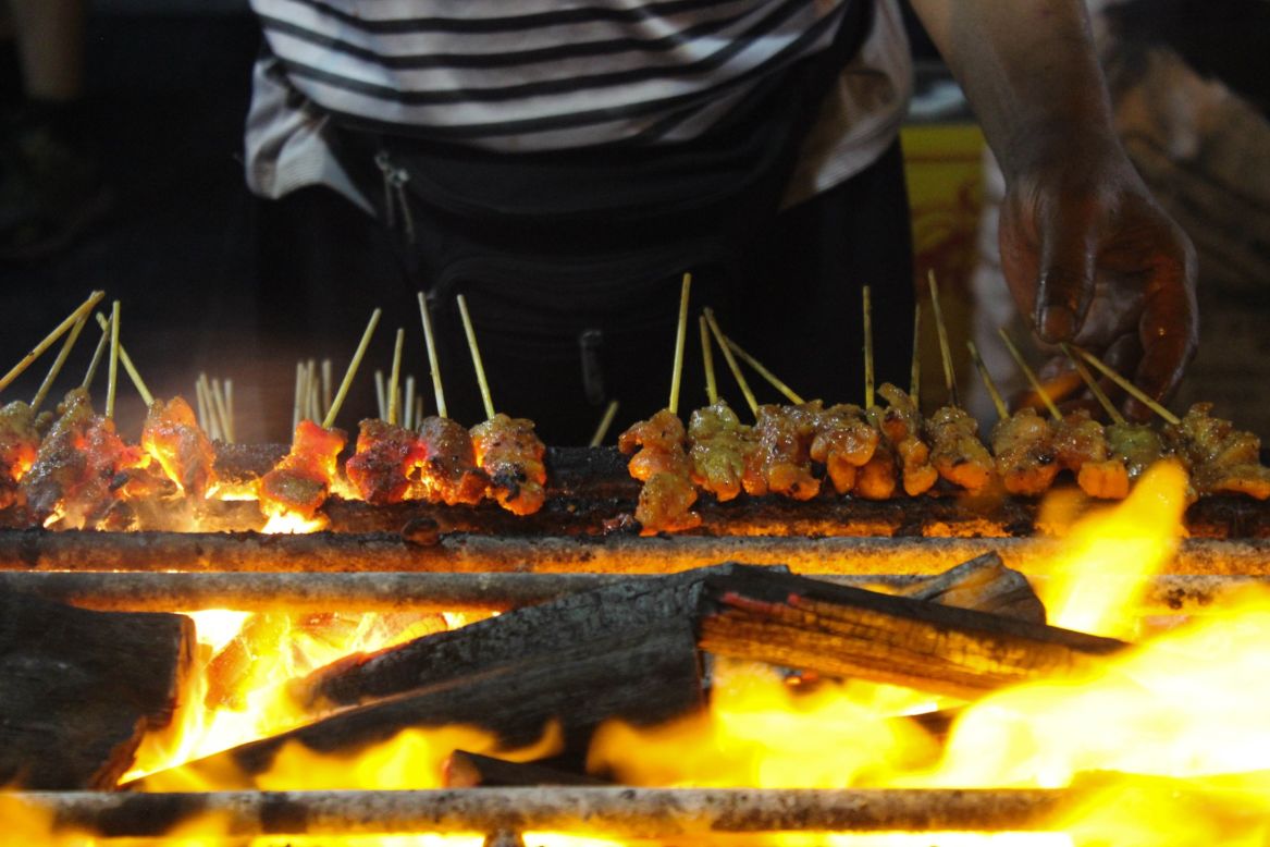 <strong>Satay sizzle:</strong> "Its openness, the smell, the smoke rising is free," Abrahim Allaudin, a second-generation stall owner, tells CNN. "There's nothing else like this in Singapore."