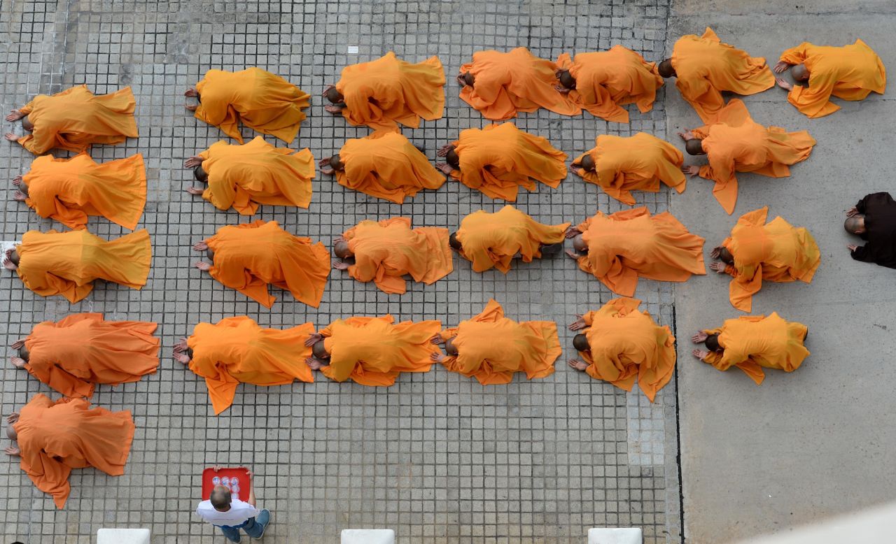 <strong>Singapore: </strong>Monks leading devotees pray outside the Kong Meng San Phor Kark See Monastery during a Buddhist ritual on the eve of Vesak Day in Singapore. 