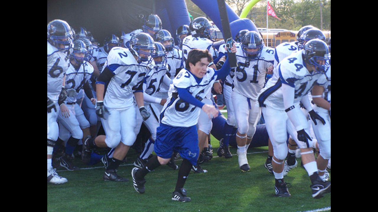 Ryan helps lead Hebron High School's football team to the field during its 2006 run to the Texas state championship. The coaches let Ryan play one snap his senior year.