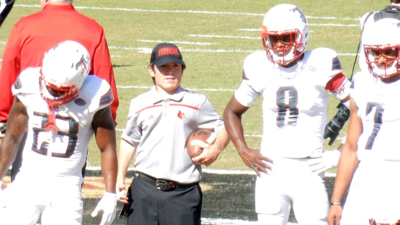 Ryan became the football team's equipment manager. Here, he stands next to 2016 Heisman winner Lamar Jackson (No. 8).