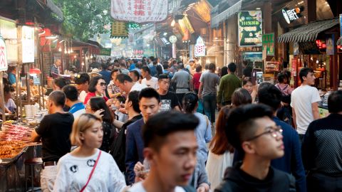 Tourist crowds pack the Muslim quarter in Xi'an, where mostly ethnic Hui Muslims run stores with traditional street food.