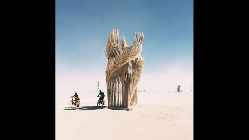 Tangential Dreams, a scalable tower built on site at Burning Man, is designed by London-based practice Mamou-Mani. It features one thousand light wooden pieces that weave into a helicoid structure.