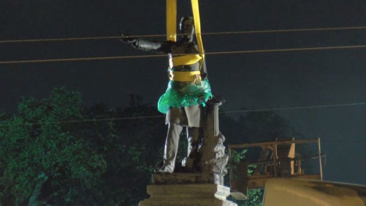 The Davis statue is wrapped in plastic and tied for removal. 