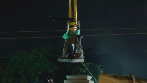 The Jefferson Davis statue was lifted from its pedestal shortly after 5 a.m. CT Thursday.