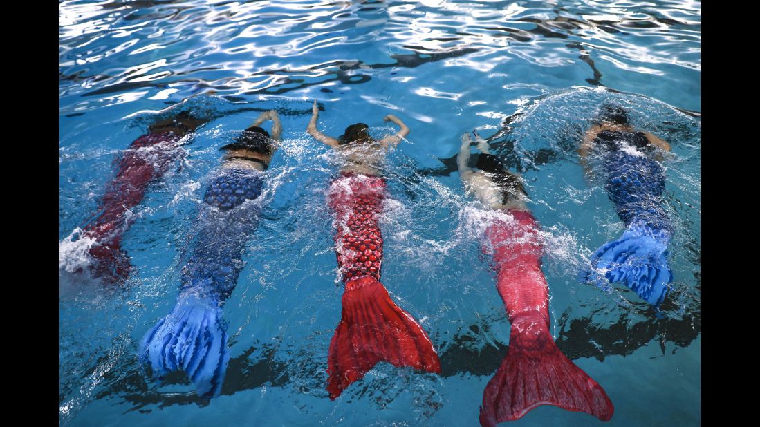 Women practice swimming with mermaid tails at AquaMermaid swimming school in Chicago. Fitness experts believe any class engaging people in long-lost passions or curiosities will benefit the health of a population.