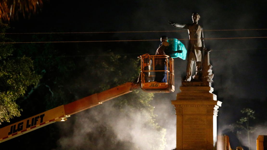 Workers prepare to take down the Jefferson Davis statue Thursday in New Orleans.