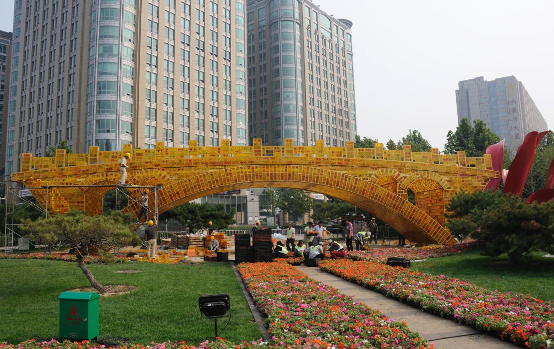 Workers prepare the "Silk Road Golden Bridge" in Beijing for the upcoming Belt and Road Forum.