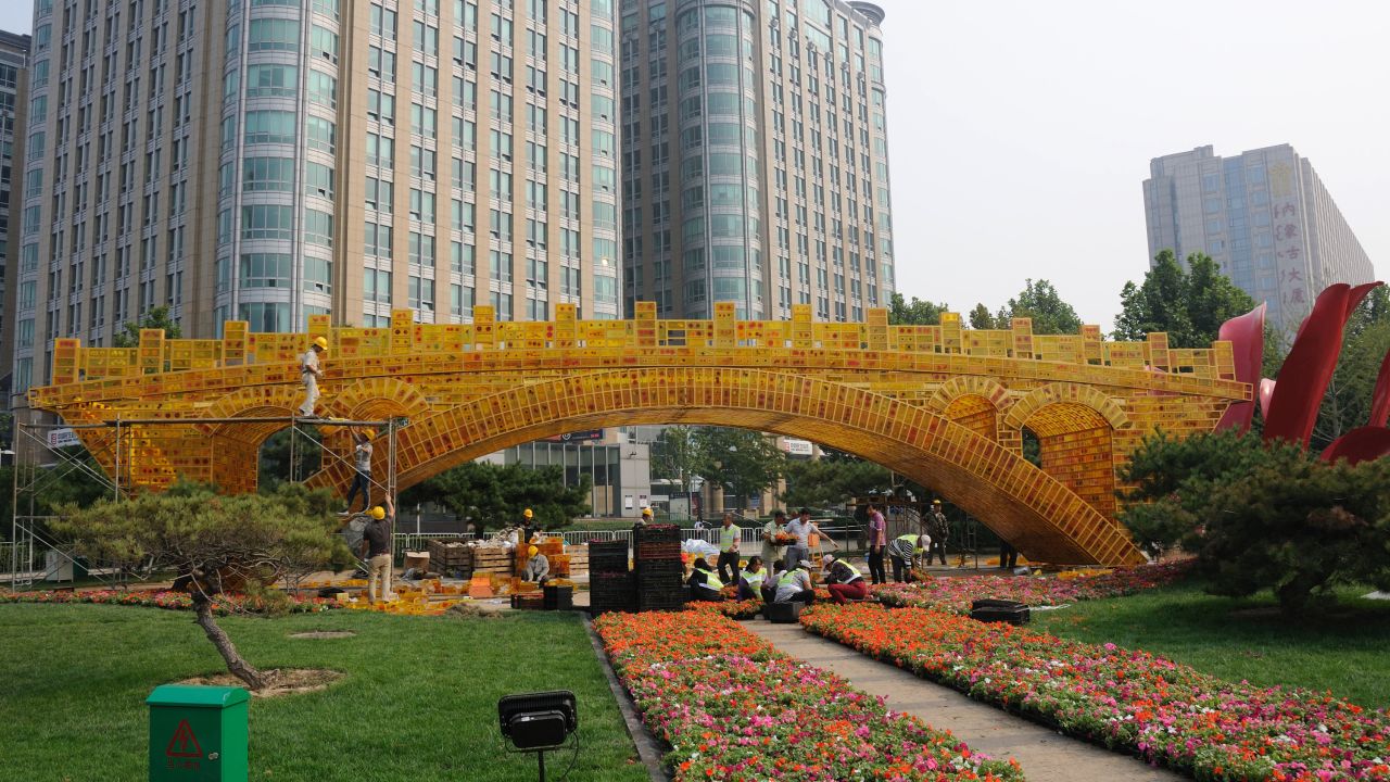 Workers prepare the "Silk Road Golden Bridge" in Beijing for the upcoming Belt and Road Forum.