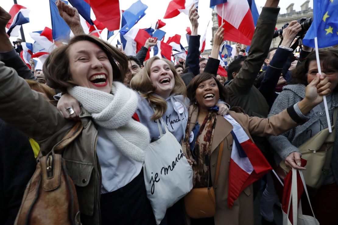 Female supporters of Macron celebrate the centrist's win front of the Louvre Museum in Paris on May 7.