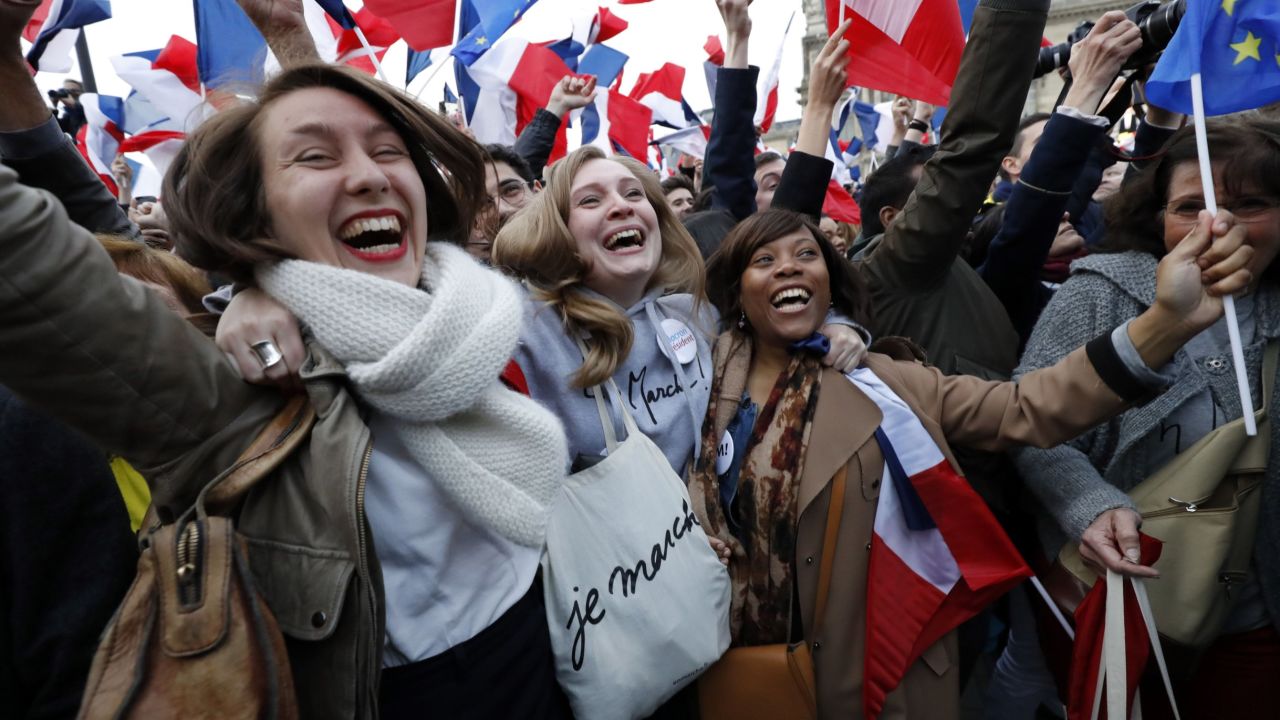 Female supporters of Macron celebrate the centrist's win front of the Louvre Museum in Paris on May 7.