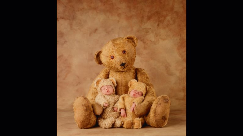 Newborn twins Jakob and Ezla cozy up to a teddy bear in 1998.