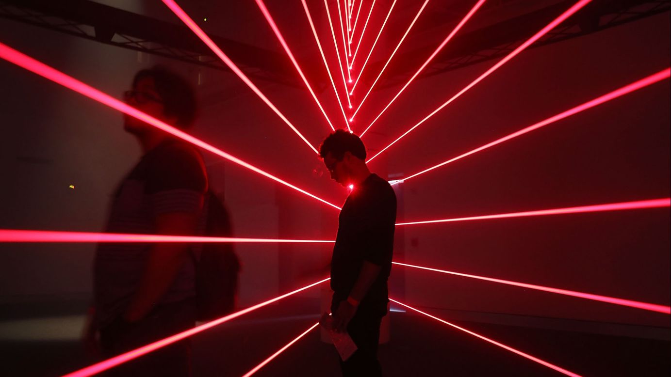 A man visits a laser exhibit at the Phillip and Patricia Frost Museum of Science, which opened Monday, May 8, in Miami.
