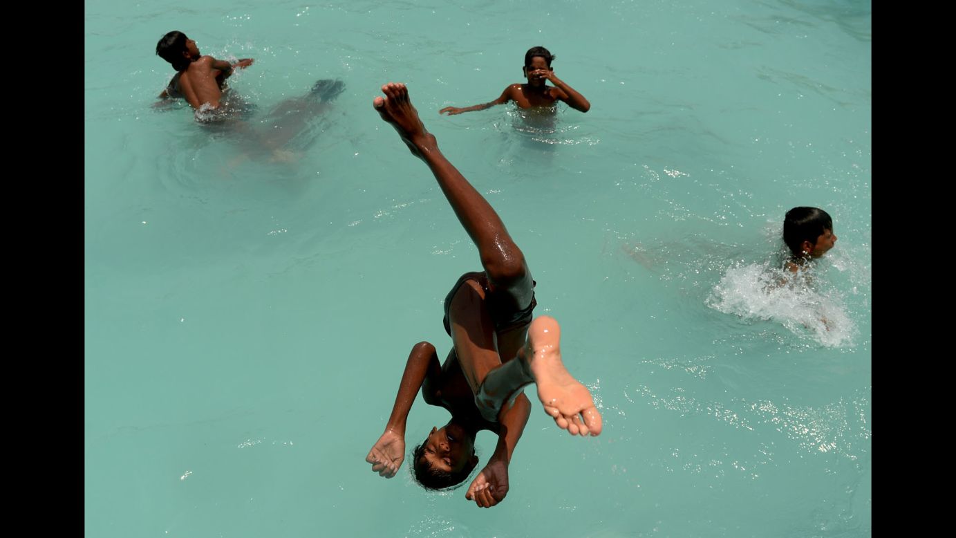 A boy dives into a swimming pool in Chennai, India, on Wednesday, May 10.